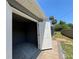 Open garage interior with white doors and grey walls at 274 Se 34Th Pl, Ocala, FL 34471