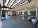 Large garage with high ceilings, epoxy floor, and multiple garage doors at 274 Se 34Th Pl, Ocala, FL 34471