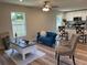 Open living room featuring a comfortable blue sofa and coffee table at 274 Se 34Th Pl, Ocala, FL 34471