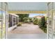 View of the backyard from inside the home, featuring outdoor seating, landscaping, and trees at 1226 Se 9Th Ave, Ocala, FL 34471