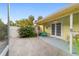 Back patio with a seating area, double doors to the home, and landscaped backyard at 1226 Se 9Th Ave, Ocala, FL 34471