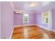 Well-lit bedroom featuring hardwood floors, two windows, and light purple walls at 1226 Se 9Th Ave, Ocala, FL 34471