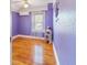 Purple bedroom with hardwood floors and window at 1226 Se 9Th Ave, Ocala, FL 34471