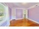 Bright bedroom featuring polished hardwood floors and an open doorway to the hall at 1226 Se 9Th Ave, Ocala, FL 34471