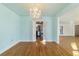 Dining room with hardwood floors, chandelier, and kitchen view at 1226 Se 9Th Ave, Ocala, FL 34471