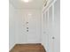 Hallway with wood flooring, white walls, and closet with louvered doors at 1226 Se 9Th Ave, Ocala, FL 34471