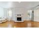 Cozy living room with a fireplace, large windows, hardwood floors, and classic design at 1226 Se 9Th Ave, Ocala, FL 34471