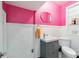 Stylish half bathroom with grey vanity, unique mirror, and vibrant pink walls at 1226 Se 9Th Ave, Ocala, FL 34471