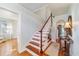 Inviting staircase with wooden steps, white risers, and built-in bookshelf detail at 1226 Se 9Th Ave, Ocala, FL 34471