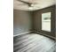 Bright bedroom with wood-look floors and a window at 201 Locust Rd, Ocala, FL 34472