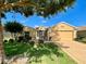 Inviting single-story home showcasing a well-manicured lawn, landscape, and a charming color palette at 16026 Sw 14Th Avenue Rd, Ocala, FL 34473