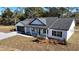 Aerial view of a white farmhouse with black roof and landscaping at Tbd W C 466 # Lot 1, Oxford, FL 34484