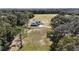 Aerial view of a house with a large yard and surrounding trees at Tbd W C 466 # Lot 1, Oxford, FL 34484