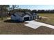 Aerial view of a white house with a dark gray roof and a long driveway at Tbd W C 466 # Lot 1, Oxford, FL 34484