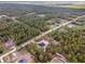 Pictureque aerial view of a new home surrounded by trees and other homes in the distance at 13359 Sw 80Th St, Dunnellon, FL 34432