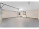 Spacious two-car garage with an epoxy floor and ample storage space at 13359 Sw 80Th St, Dunnellon, FL 34432