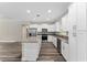Spacious kitchen boasts stainless steel appliances, granite countertops, and white cabinetry at 13359 Sw 80Th St, Dunnellon, FL 34432
