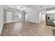 Open living space with hardwood flooring, a front door, and access to kitchen and bathroom at 13359 Sw 80Th St, Dunnellon, FL 34432