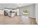 Open-concept living room and kitchen area with hardwood flooring and sliding glass doors at 13359 Sw 80Th St, Dunnellon, FL 34432