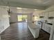 White kitchen with island and view to backyard at 2 Se Chinica Dr, Summerfield, FL 34491