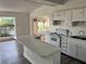 White kitchen with island and lake view at 2 Se Chinica Dr, Summerfield, FL 34491