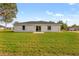 Large backyard with green grass and single-story home at 16588 Sw 25Th Terrace Rd, Ocala, FL 34473