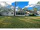 Expansive backyard featuring lush lawn, mature trees, and a screened lanai, perfect for outdoor relaxation and enjoyment at 8655 Sw 98Th Street Rd # G, Ocala, FL 34481