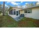 Exterior view of home with a sunroom and an air conditioning unit in the backyard at 8655 Sw 98Th Street Rd # G, Ocala, FL 34481