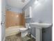 Bathroom with a single sink, a tiled shower with a bathtub, and a modern toilet at 8655 Sw 98Th Street Rd # G, Ocala, FL 34481