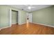 Bedroom with hardwood floors, a ceiling fan, and a closet with doors at 8655 Sw 98Th Street Rd # G, Ocala, FL 34481