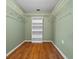 Walk in closet with wood floor, built in shelving and painted green walls at 8655 Sw 98Th Street Rd # G, Ocala, FL 34481