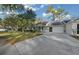 Home featuring an attached garage and long driveway at 8655 Sw 98Th Street Rd # G, Ocala, FL 34481