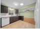 Open kitchen with dark wood cabinetry, light granite countertops and tile floors at 8655 Sw 98Th Street Rd # G, Ocala, FL 34481