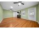 Living room with open concept to kitchen, wood floors, natural light from window and ceiling fans at 8655 Sw 98Th Street Rd # G, Ocala, FL 34481