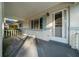Charming covered front porch featuring white railings, brick accents, and a welcoming entrance at 8655 Sw 98Th Street Rd # G, Ocala, FL 34481