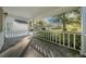 Charming covered front porch featuring white railings and views of the surrounding lawn at 8655 Sw 98Th Street Rd # G, Ocala, FL 34481