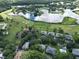 Aerial view showcasing community, golf course, and lake at 567 Midway Trak # H102, Ocala, FL 34472
