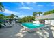 Inviting community pool with lounge chairs and tropical landscaping at 567 Midway Trak # H102, Ocala, FL 34472