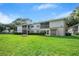 Low angle view of condo building showcasing well-manicured lawn and building facade at 567 Midway Trak # H102, Ocala, FL 34472