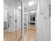 Long hallway with mirrored closet doors at 567 Midway Trak # H102, Ocala, FL 34472