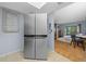 Kitchen with stainless steel refrigerator and view into living area at 567 Midway Trak # H102, Ocala, FL 34472