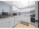 Modern kitchen with sleek white cabinetry, stainless steel appliances, and granite countertops at 567 Midway Trak # H102, Ocala, FL 34472