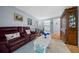 Bright living room boasts tile flooring, a comfortable sofa and a decorative hutch at 567 Midway Trak # H102, Ocala, FL 34472