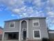 Two-story house with gray exterior and attached garage at 11749 Sw 57Th Ter, Ocala, FL 34476