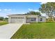 Newly constructed single-story home with a two-car garage and a spacious lawn at 16612 Sw 31St Cir, Ocala, FL 34473