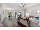 Open concept living room with hardwood floors, a sofa, and a view into the kitchen and dining area at 16612 Sw 31St Cir, Ocala, FL 34473