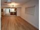 Living room with wood-look floors and a view into the kitchen at 11001 Se Sunset Harbor Rd # A08, Summerfield, FL 34491