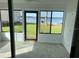 Sunroom with lake view and tiled floor at 11001 Se Sunset Harbor Rd # A08, Summerfield, FL 34491