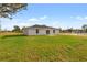 Large grassy backyard showcasing the home's rear elevation at 17273 Sw 20Th Court Rd, Ocala, FL 34473