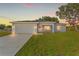 Newly built home showcasing a two-car garage and well-maintained lawn at dusk at 17273 Sw 20Th Court Rd, Ocala, FL 34473